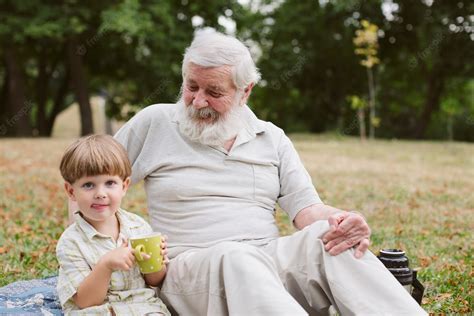free photo grandpa and grandson at picnic in park