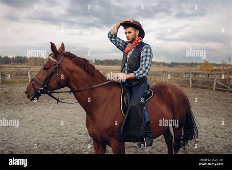cowboy riding horse gun high resolution stock photography  images