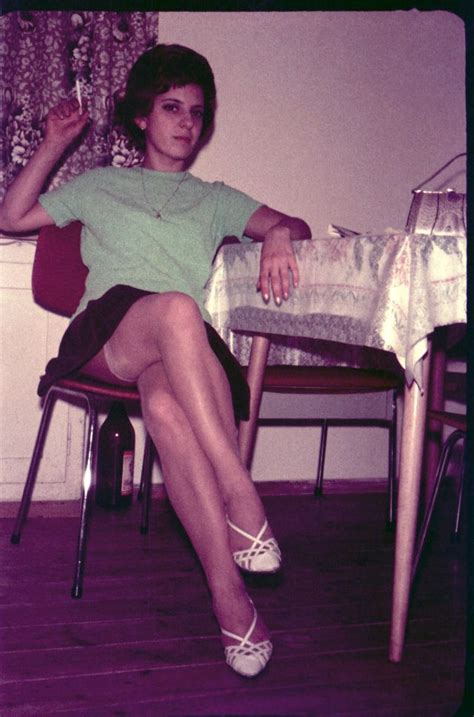 A Woman Sitting At A Table With Her Legs Crossed