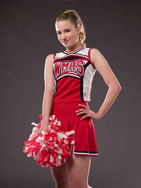 a woman in a cheerleader uniform holding a pom pom