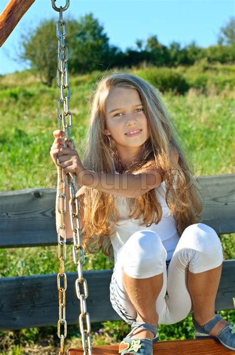 eight years old long hair girl posing outdoors stock