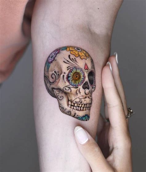 micro realistic sugar skull tattoo located
