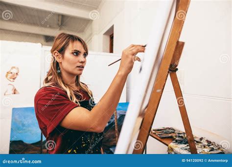 woman painter painting  canvas   studio stock photo image
