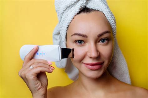 premium photo ultrasonic scrubber for facial skin cleansing girl in