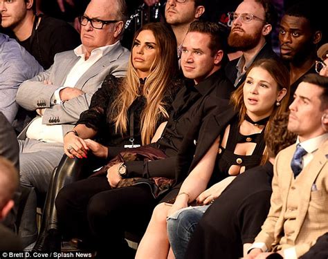 katie price covers up in a chic blouse at boxing match