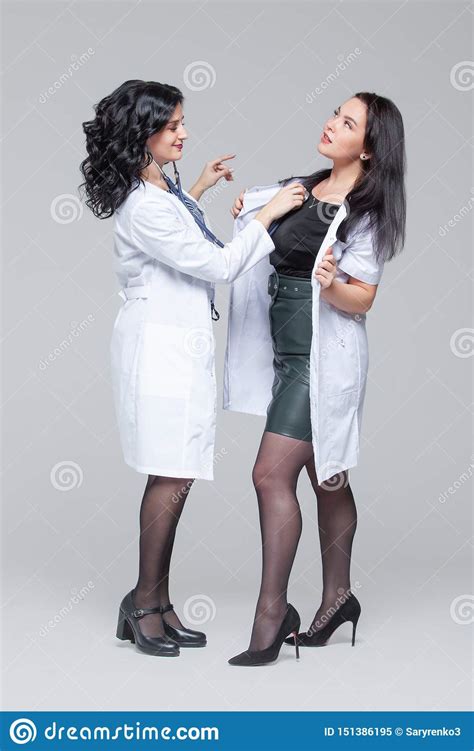 Female Doctor Examining Another Woman With Stethoscope Stock Image