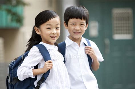 chinese children  backpacks posing  street standing girl