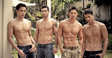 Three Men Standing Next To Each Other With No Shirts On