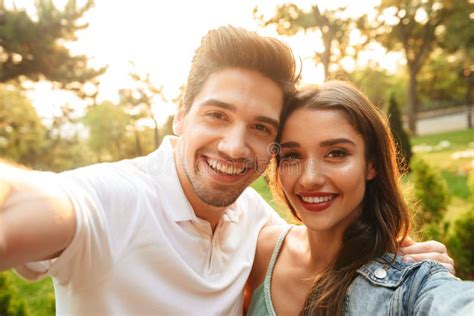 Loving Couple Walking Outdoors While Make A Selfie By Camera Stock