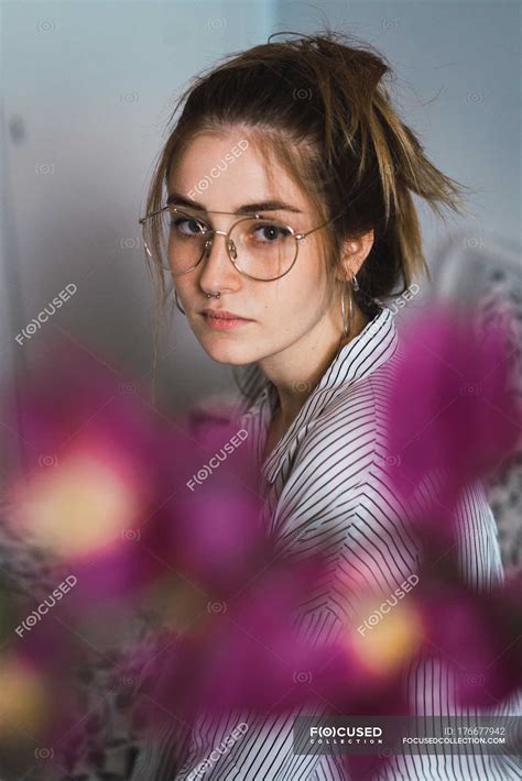 portrait of brunette woman wearing trendy glasses and