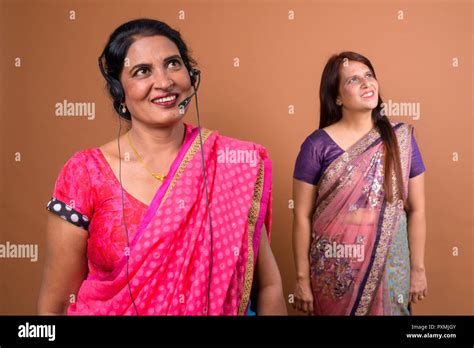 happy mature indian woman call center representative thinking stock