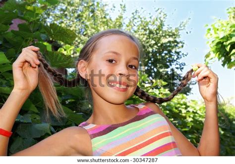 Cheerful Preteen Girl Showing Her Braids Foto De Stock 30347287
