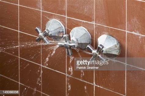 A Shower Faucet Handle Spraying Leaking Water Photo Getty Images
