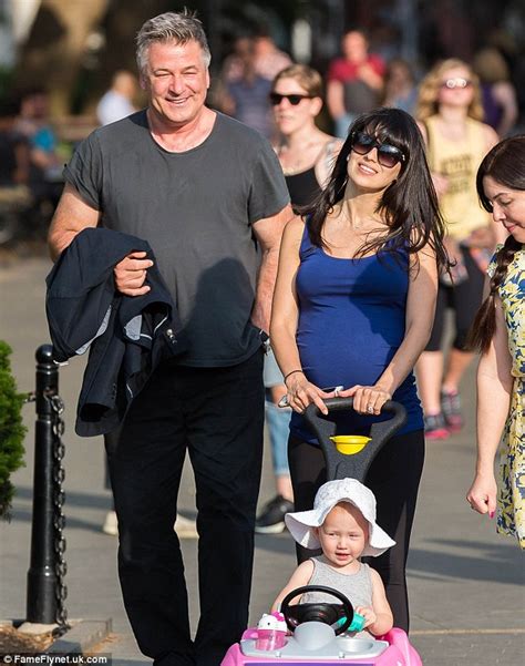 alec baldwin dotes on pregnant wife hilaria as she dresses her growing belly in a tight shirt