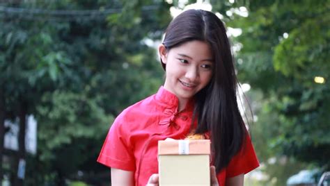 portrait of thai teen beautiful girl in chinese dress happy new year and open box t unhappy
