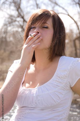 Teen Smokes A Cigarette Next To The River Brunette Girl Enjoys A Fag