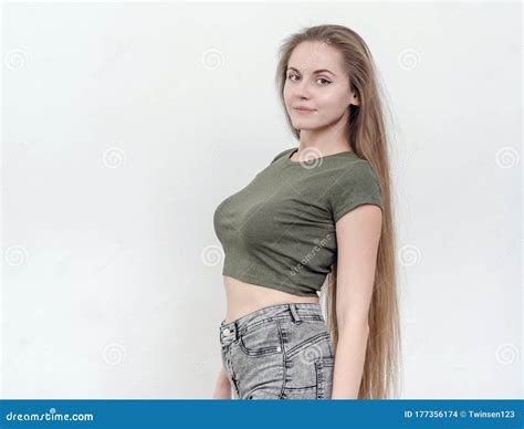 Nice Girl With Beautiful Breasts In A Green T Shirt Posing On Ca Stock