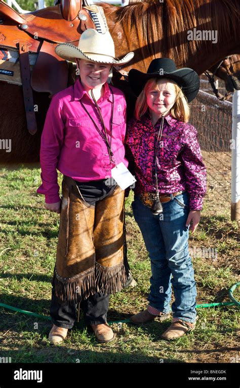 Two Young Cowgirls Posing For The Camera At Prca Rodeo Small Town