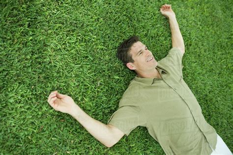 man lying  grass smiling stock photo dissolve