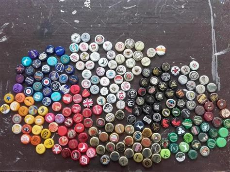 man collects bottle caps   year  carefully arranges   plain wooden table