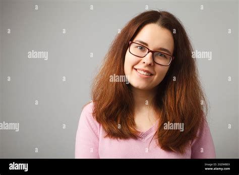 Redhead Long Haired Girl With Glasses Smiles Looking At The Camera