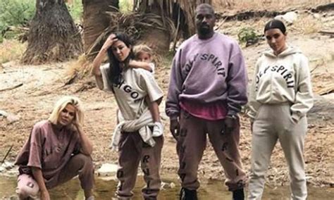 kim kardashian poses in 225 holy spirit hoodie from kanye