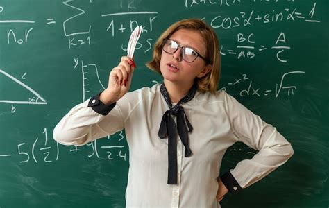 Free Photo Strict Young Female Teacher Wearing Glasses Standing In