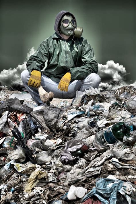 man in a gas mask sitting on the garbage and holding a bone stock image