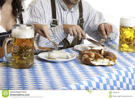 oktoberfest couple having beer stein and meal stock image