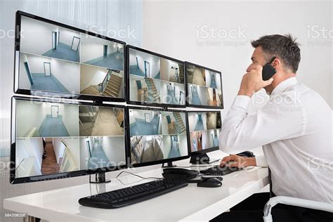 Security System Operator Looking At Cctv Footage Stock