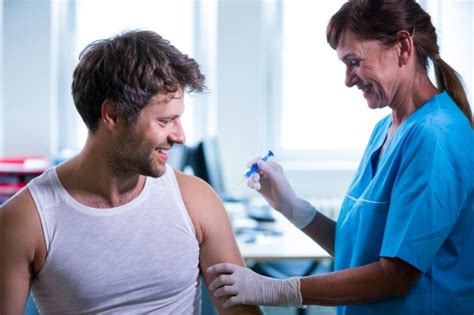 female doctor giving an injection to a patient photo free download