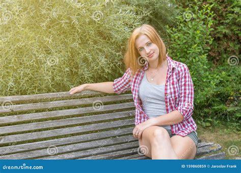 Young Woman Is Sitting On The Bench Outdoors Stock Image Image Of