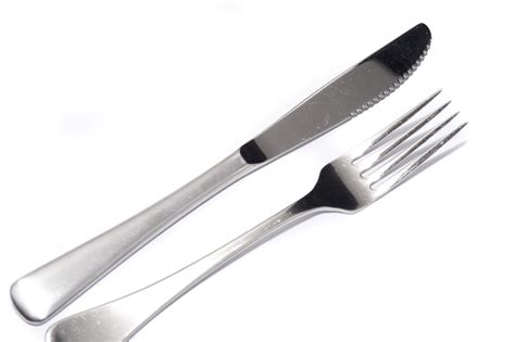 silver knife  fork diagonally  white  stock image