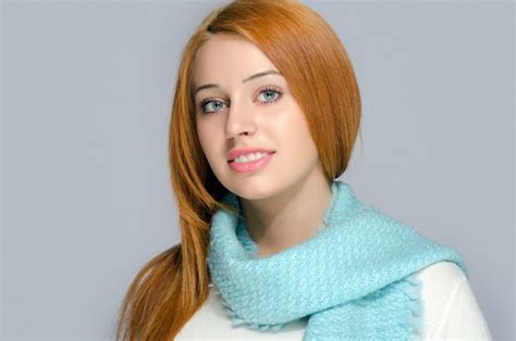 Portrait Of A Beautiful Red Hair Woman Wearing A Blue