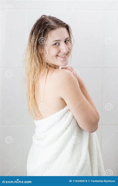 Portrait Of Smiling Blonde Woman In White Towel After Having Shower