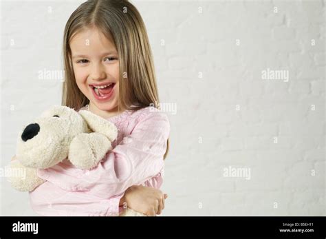 girl holding  stuffed animal  laughing  camera stock photo alamy