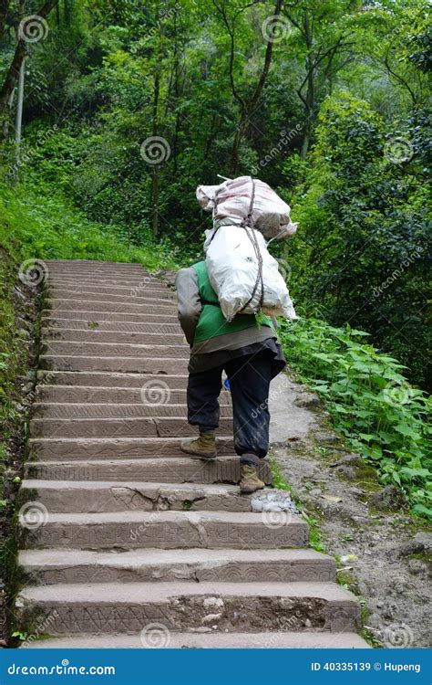 chinese man carry goods   mountains editorial stock image image  labor basket
