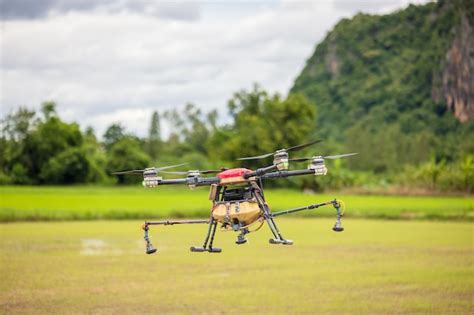 premium photo agriculture drones fly  rice fields sprinkling fertilizer high resolution