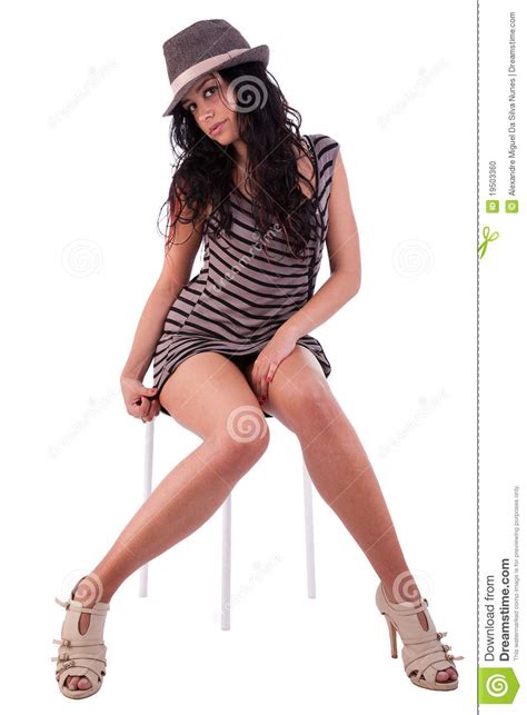 Woman With Elegant Dress Hat Sitting On A Bench Stock