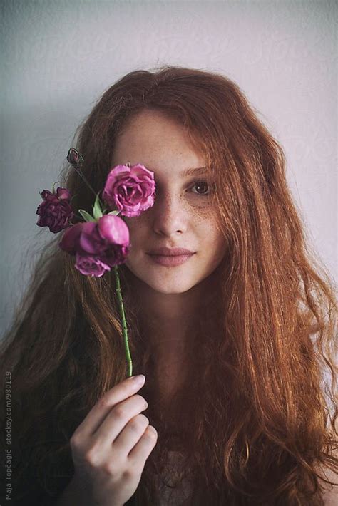Portrait Of A Beautiful Redhead With Freckles Holding A Rose By Maja