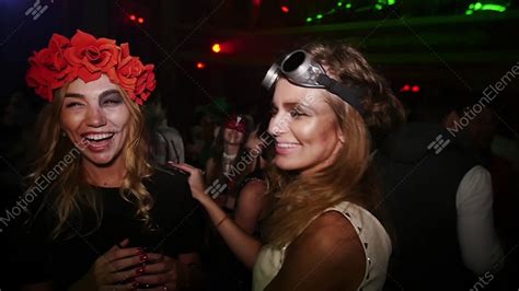sexy lesbian kiss at halloween party in nightclub flower rim aviator