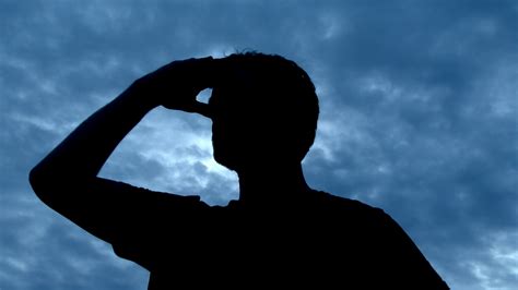 silhouetted person  black searching   blue sky
