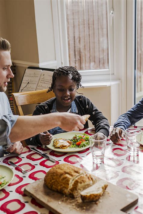 dad with son and daughter eating at the table first4adoption
