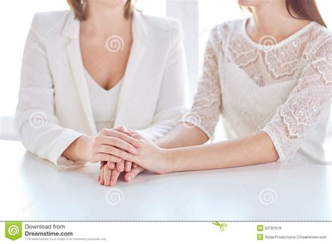 close up of happy married lesbian couple hands stock image