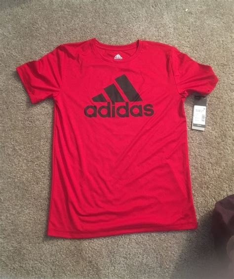 originally     offer red polyester  shirt  black adidas logo   front