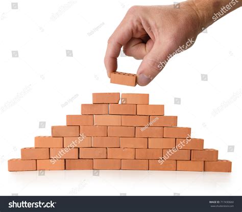 concept building construction hand placing brick stock photo
