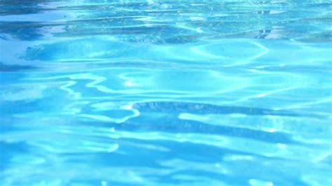swimming pool water surface  sparkling light reflections stock