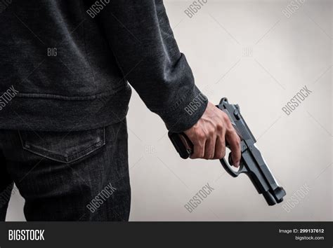 man holding gun hand image photo  trial bigstock