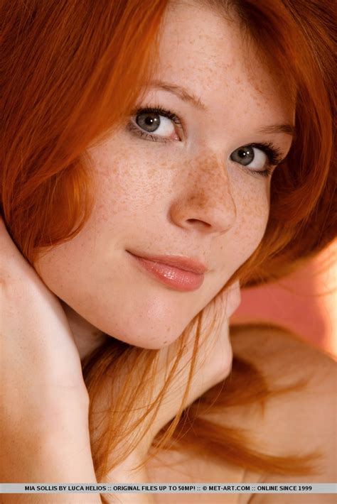 redhead glamour model mia sollis posing in black lingerie in teasing manner