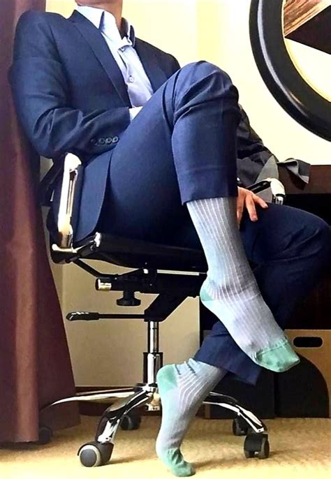 the boss barefoot on dress socks in his office mens